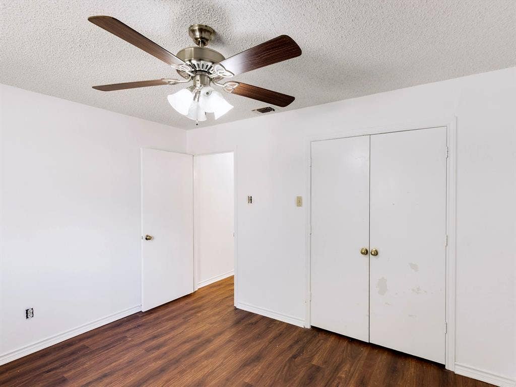 219 N Beltwoods Drive, DeSoto, TX 75115 Wood-finish flooring, white walls, and a ceiling fan with integrated lighting