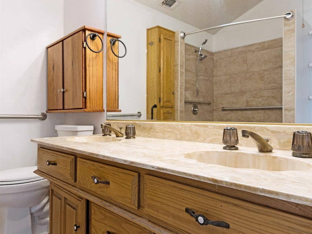 219 N Beltwoods Drive, DeSoto, TX 75115 Dual vanity with integrated sinks and a stone-finish countertop
