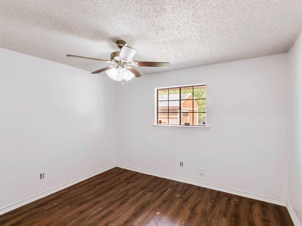 219 N Beltwoods Drive, DeSoto, TX 75115 Wood-finish flooring, white walls, and a ceiling fan with integrated lighting