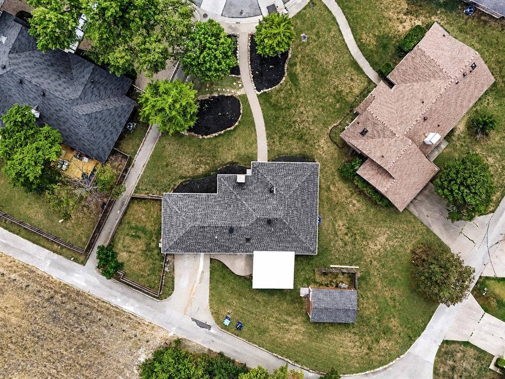 219 N Beltwoods Drive, DeSoto, TX 75115 Expansive lot featuring a detached storage shed, mature trees, and a paved driveway