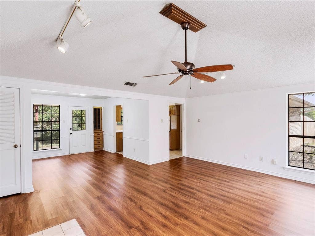 219 N Beltwoods Drive, DeSoto, TX 75115 Vaulted ceiling with a wood-finish ceiling fan, recessed lighting, and track lighting