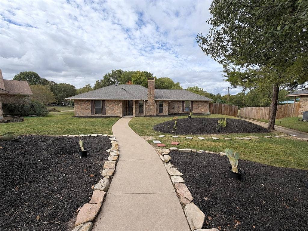 219 N Beltwoods Drive, DeSoto, TX 75115 Brick exterior with a shingle roof and a prominent chimney