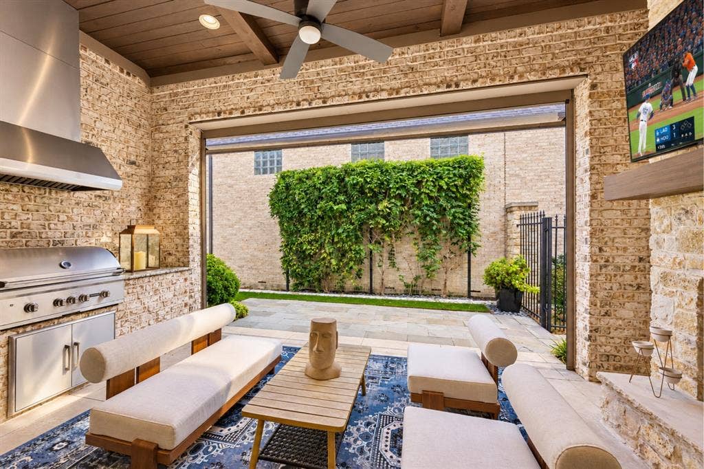 6816 Cousteau Court, Plano, TX 75024 Covered outdoor patio with a built-in grill, ceiling fan, and exposed wood beam ceiling