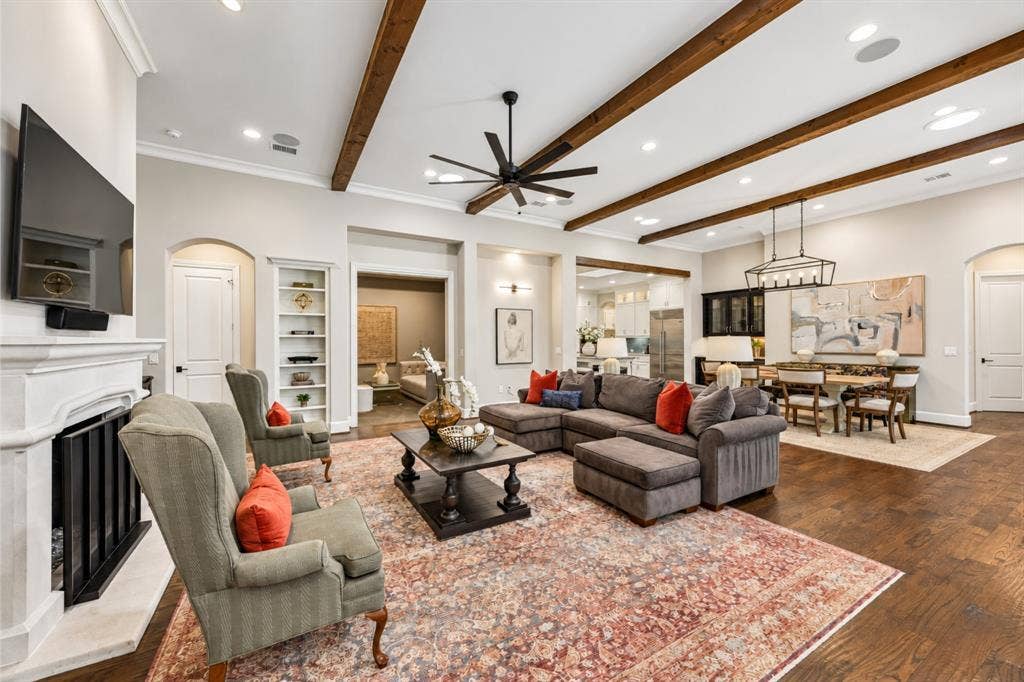 6816 Cousteau Court, Plano, TX 75024 Exposed ceiling beams, recessed lighting, fireplace with mantel, dark wood-finish flooring, and built-in shelving