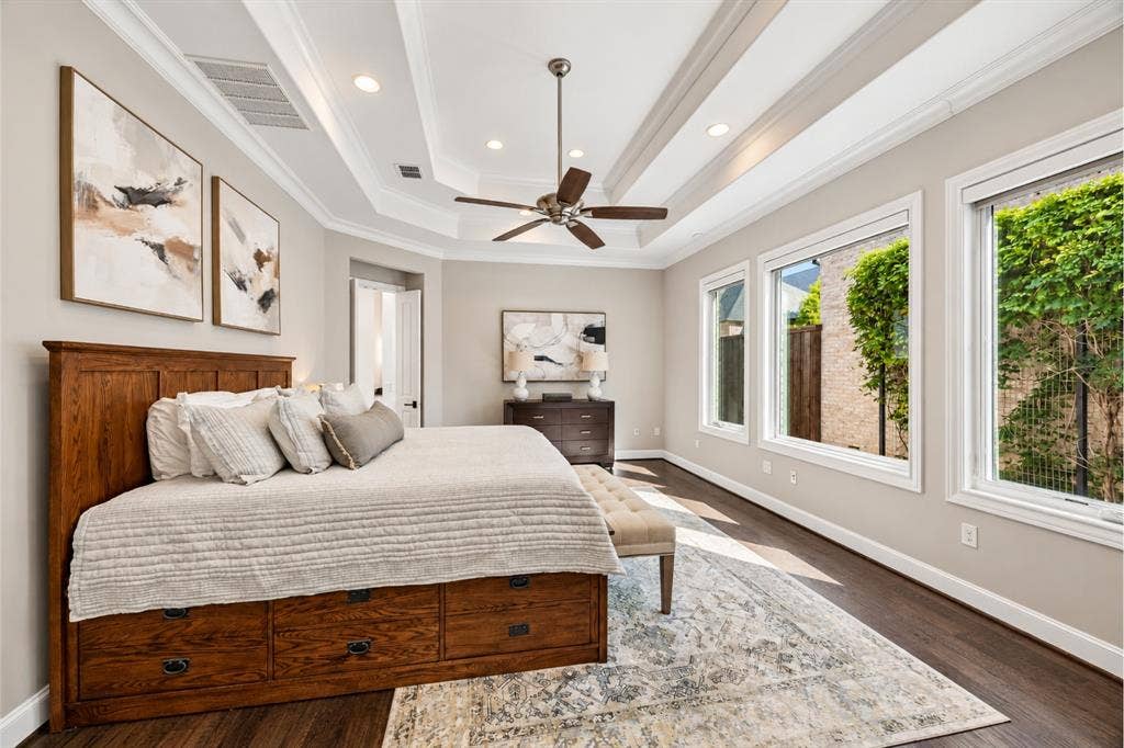 6816 Cousteau Court, Plano, TX 75024 Tray ceiling with recessed lighting, dark wood-finish flooring, multiple windows, ceiling fan, and crown molding