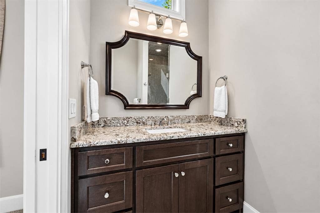 6816 Cousteau Court, Plano, TX 75024 Rich wood-finish vanity with ample storage drawers and cabinet space