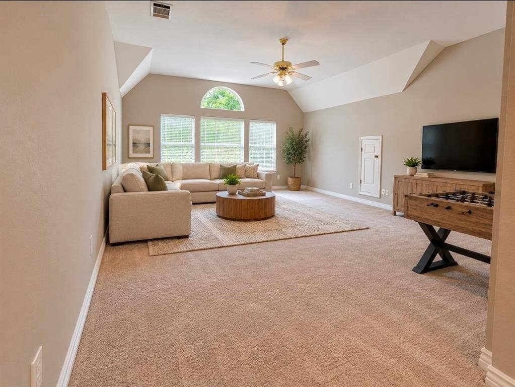 3708 Stockport Drive, Plano, TX 75025 Vaulted ceiling with a ceiling fan, arched window, wall-to-wall carpeting, and wood-finish cabinetry