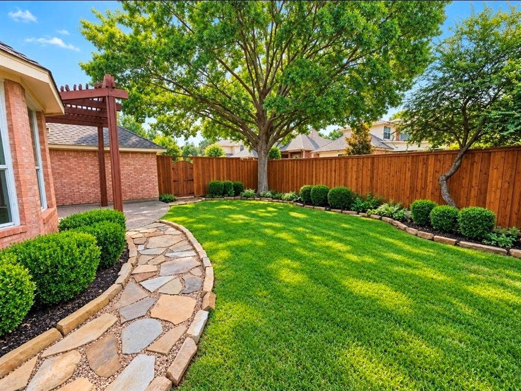 3708 Stockport Drive, Plano, TX 75025 Expansive backyard featuring a natural stone pathway, wood pergola, mature trees, and a wooden privacy fence