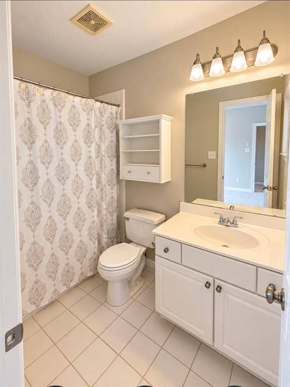 3708 Stockport Drive, Plano, TX 75025 White tile flooring, white vanity with integrated sink, four-light vanity fixture, built-in wall cabinet, and wall-mounted mirror