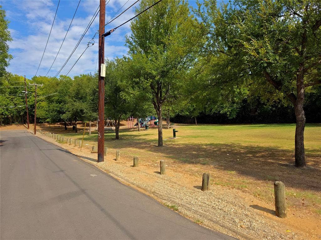 2855 Peary Avenue, Dallas, TX 75215 Expansive green space featuring mature trees and a dedicated recreational area