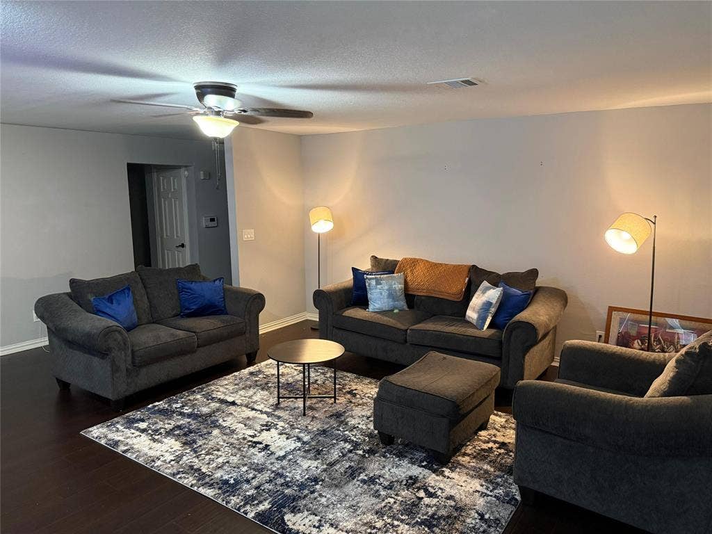 Wood-finish flooring with a ceiling fan light fixture
