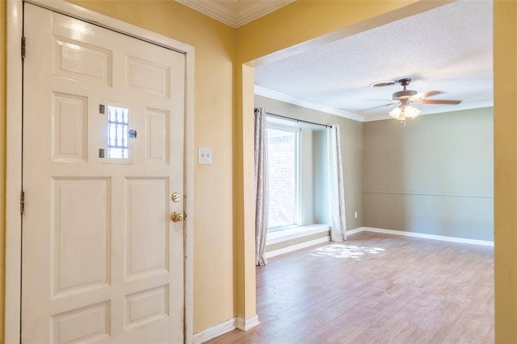 Wood-finish flooring throughout, complemented by a window seat, and crown molding