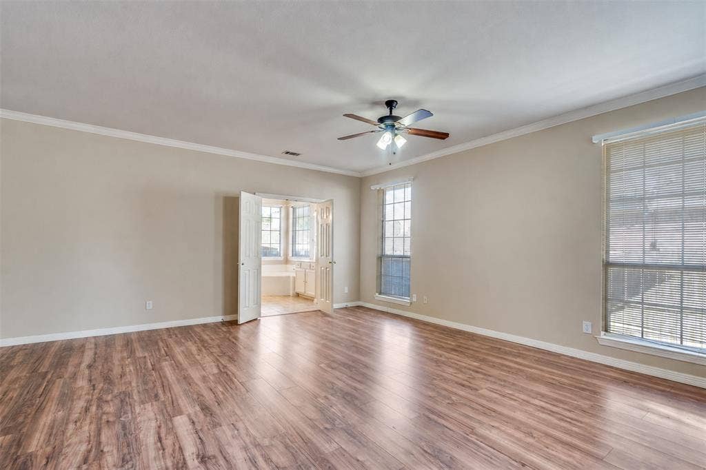 2305 Pittner Lane, Plano, TX 75025 Wood-finish flooring, crown molding, double pane windows, and a ceiling fan