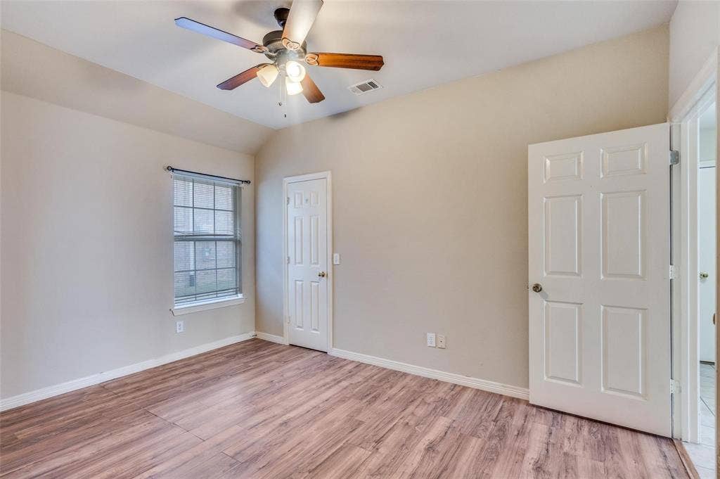 2305 Pittner Lane, Plano, TX 75025 Vaulted ceiling with a ceiling fan, wood-finish flooring, and a paneled door