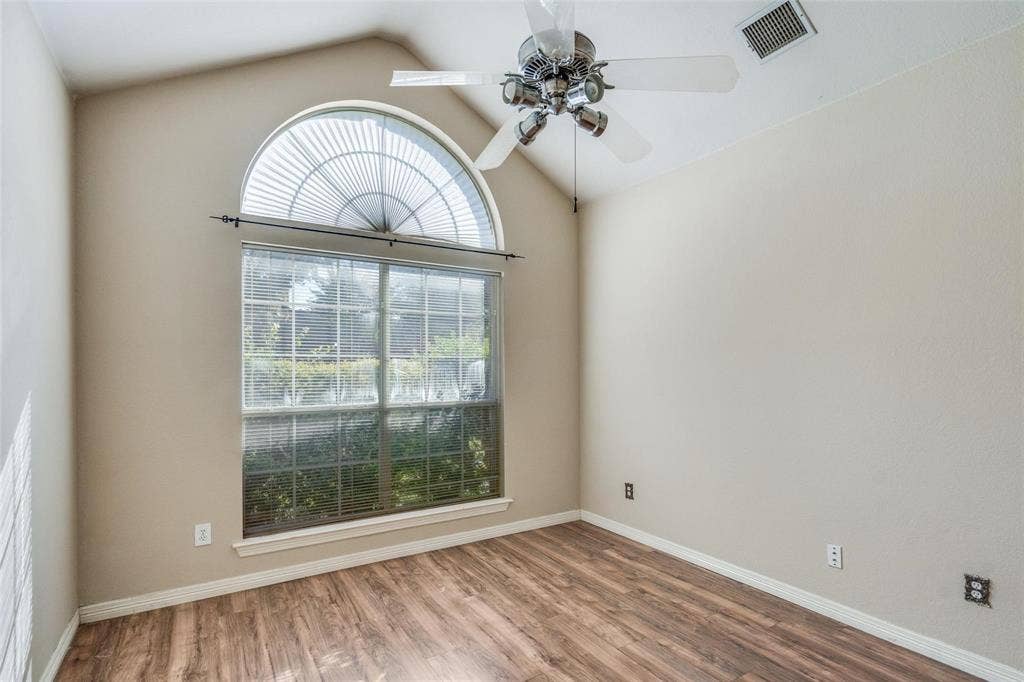 2305 Pittner Lane, Plano, TX 75025 Vaulted ceiling, arched transom window, large rectangular window, wood-finish flooring, and ceiling fan