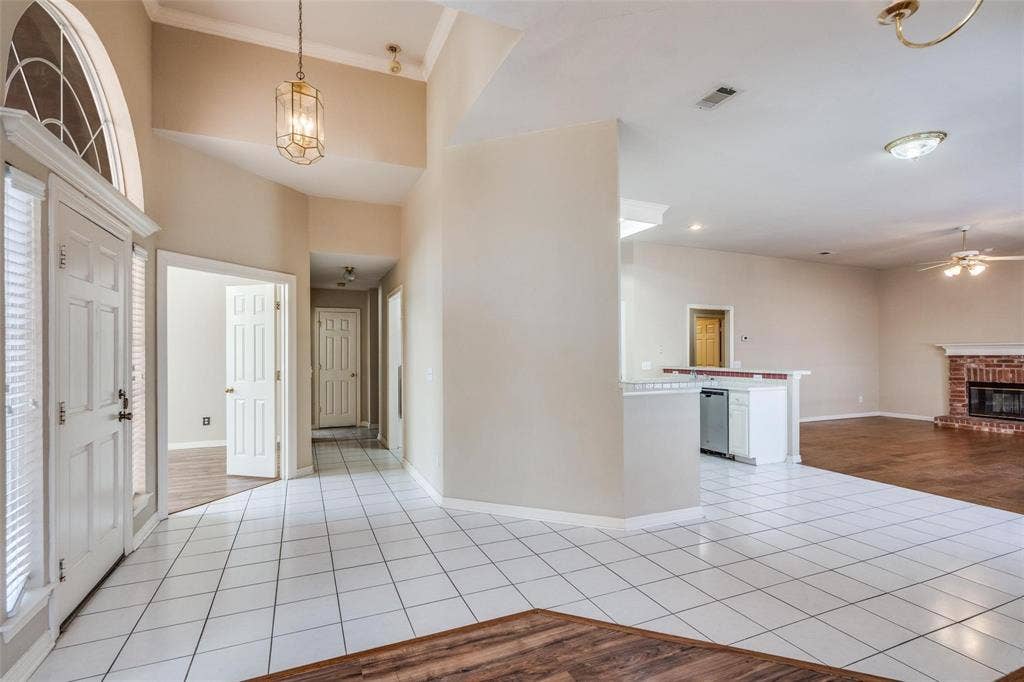 2305 Pittner Lane, Plano, TX 75025 Entryway with vaulted ceilings and a transom window, featuring ceramic tile flooring