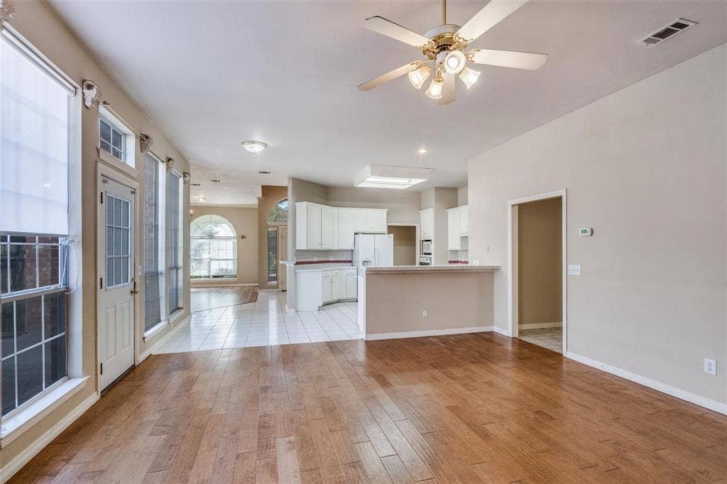 2305 Pittner Lane, Plano, TX 75025 Hardwood-style flooring throughout, white tiled flooring, arched window, ceiling fan with integrated lighting, and recessed lighting