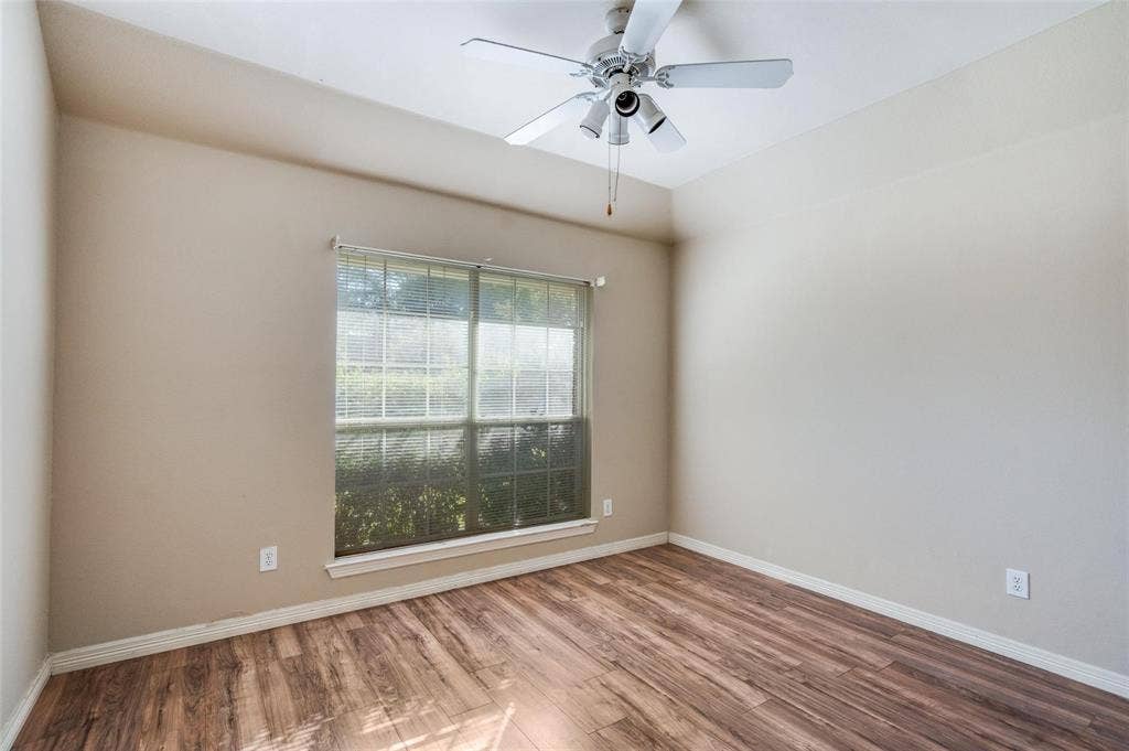 2305 Pittner Lane, Plano, TX 75025 Vaulted ceiling with a ceiling fan light fixture, wood-finish flooring, and a large window with blinds