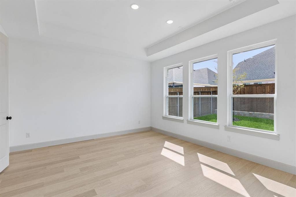 2624 Radiant Way, Celina, TX 75009 High ceilings, beautiful flooring and a wall of windows overlooking the private back yard create a peaceful and relaxing owner's suite.