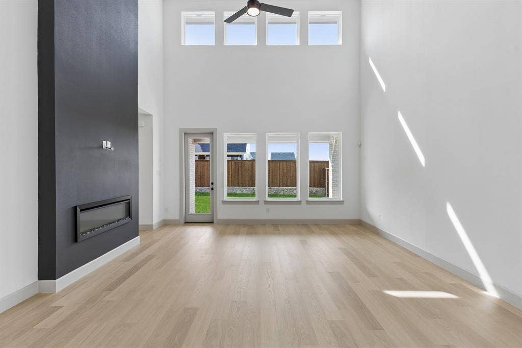 2624 Radiant Way, Celina, TX 75009 Light and bright with a striking fireplace accent wall, the entire family will love gathering in this wonderful family room!