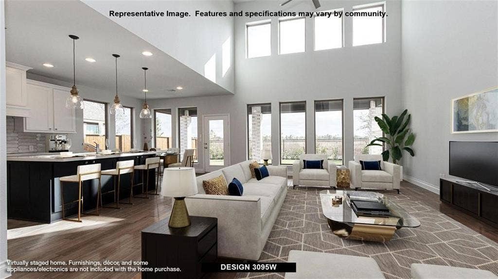 4237 Capstone Road, Midlothian, TX 76065 Double-height ceiling, wood-finish flooring, recessed lighting, expansive windows, and an open-concept kitchen with an island