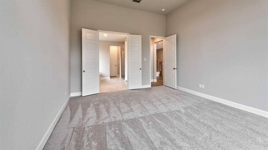 4237 Capstone Road, Midlothian, TX 76065 Spacious room featuring neutral carpeting, light-toned walls, and multiple panel doors