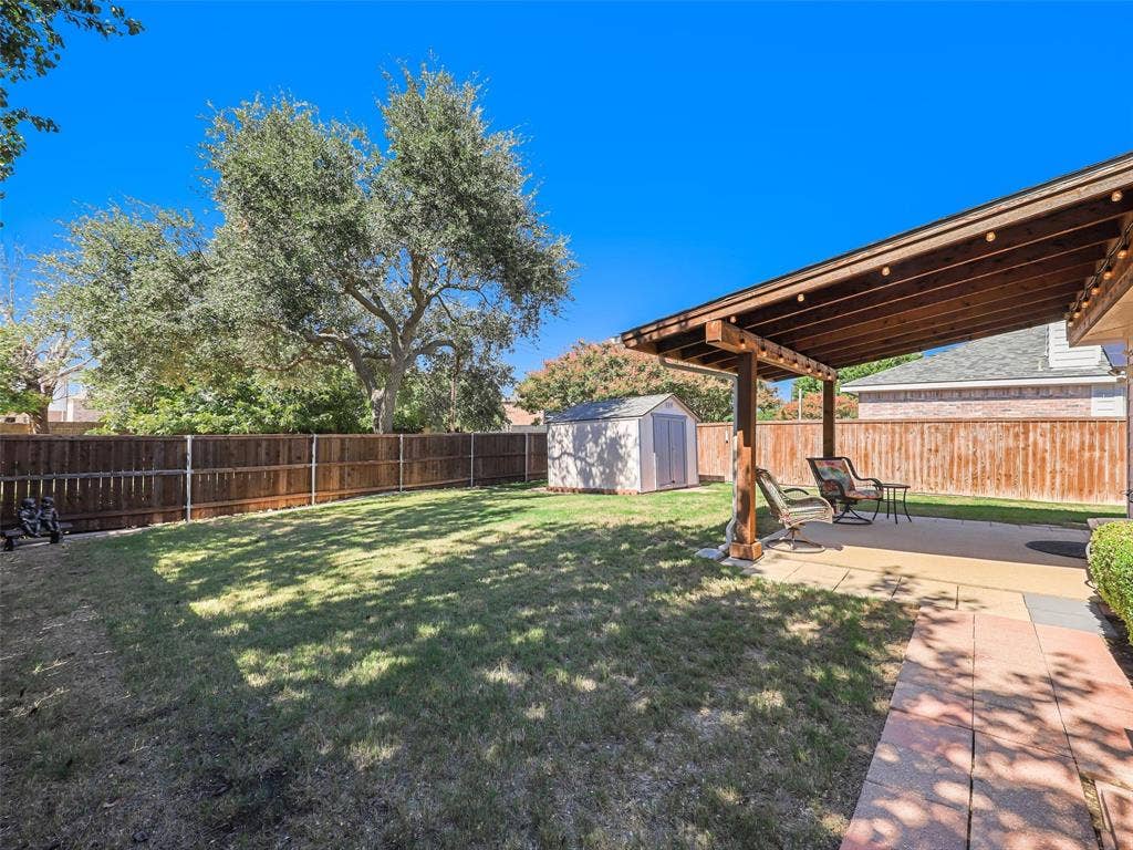 2109 Lilac Circle, McKinney, TX 75071 Large backyard with wood covered patio and storage shed