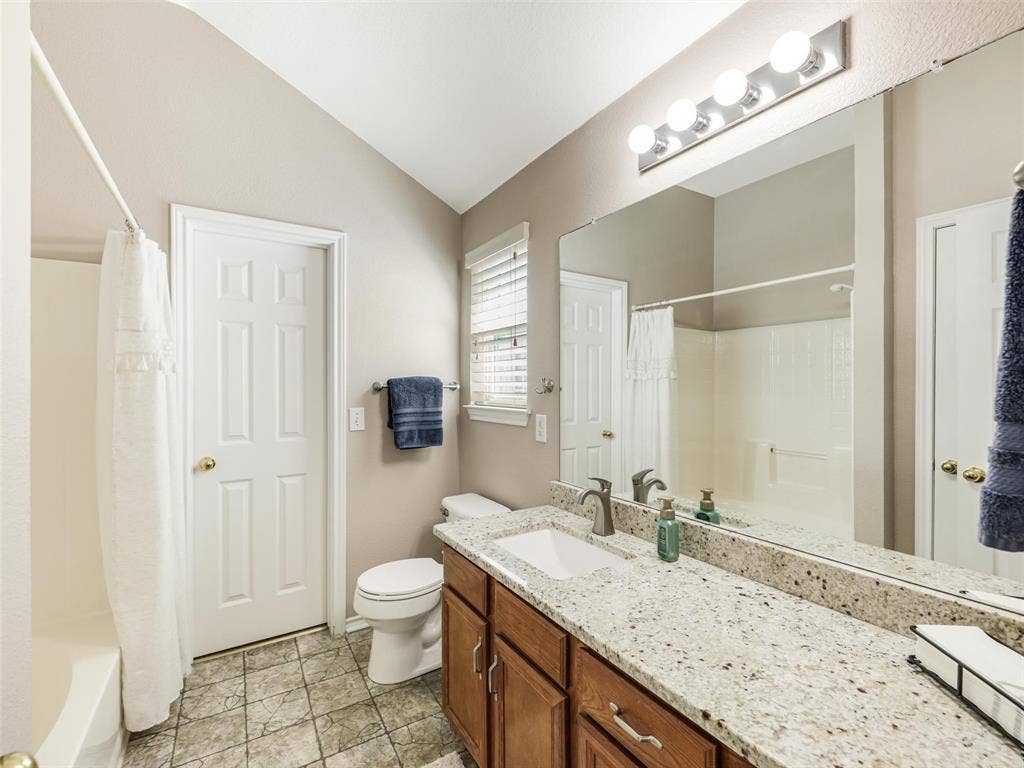 2109 Lilac Circle, McKinney, TX 75071 Primary bath features soaking tub with shower head and granite counters