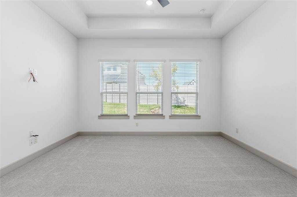 4524 Sunfish Lane, McKinney, TX 75071 Recessed ceiling with a flush-mount light fixture, three large windows with horizontal blinds, neutral carpet flooring, and contemporary baseboards