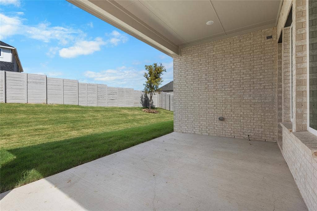4524 Sunfish Lane, McKinney, TX 75071 Covered patio with a concrete surface, brick exterior, and a privacy fence