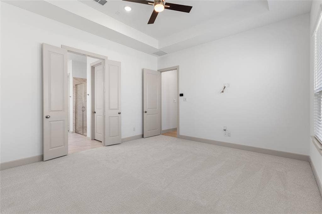4524 Sunfish Lane, McKinney, TX 75071 Tray ceiling with a ceiling fan, light-toned carpeting, white walls, and a window with blinds