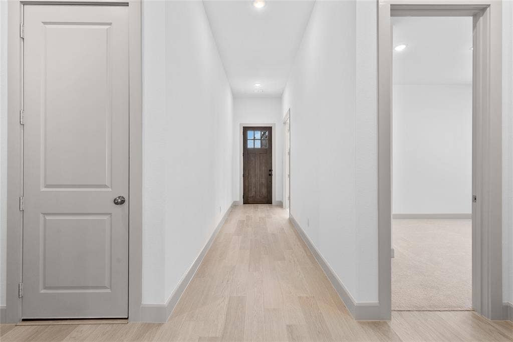 4524 Sunfish Lane, McKinney, TX 75071 Hallway featuring light wood-finish flooring, recessed lighting, and a paneled entry door