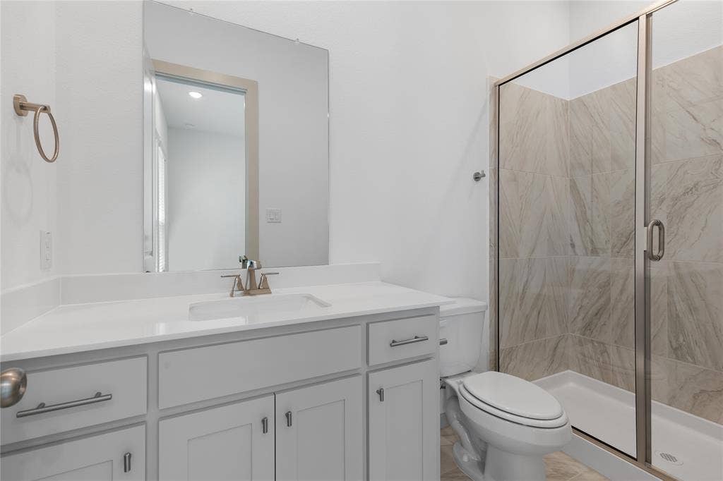 4524 Sunfish Lane, McKinney, TX 75071 White vanity with a rectangular undermount sink and brushed nickel faucet
