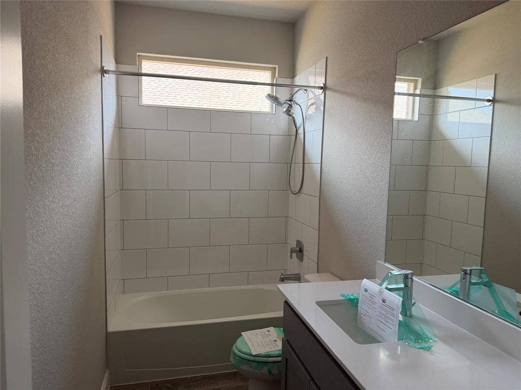5213 Meadow Lane, Krum, TX 76249 Bathtub with subway tile surround, chrome shower fixtures, and a transom window
