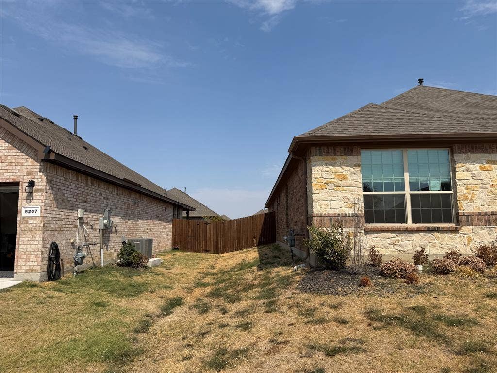 5213 Meadow Lane, Krum, TX 76249 Brick and stone exterior with a gabled roof