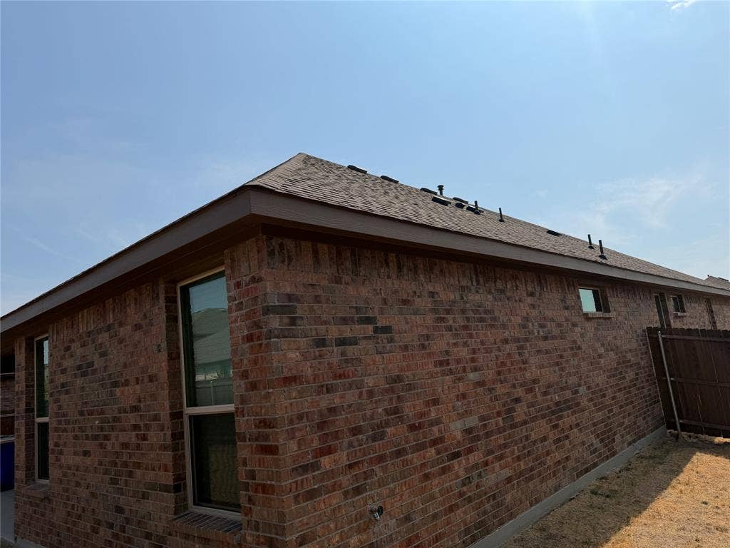 5213 Meadow Lane, Krum, TX 76249 Red brick exterior with a shingle roof