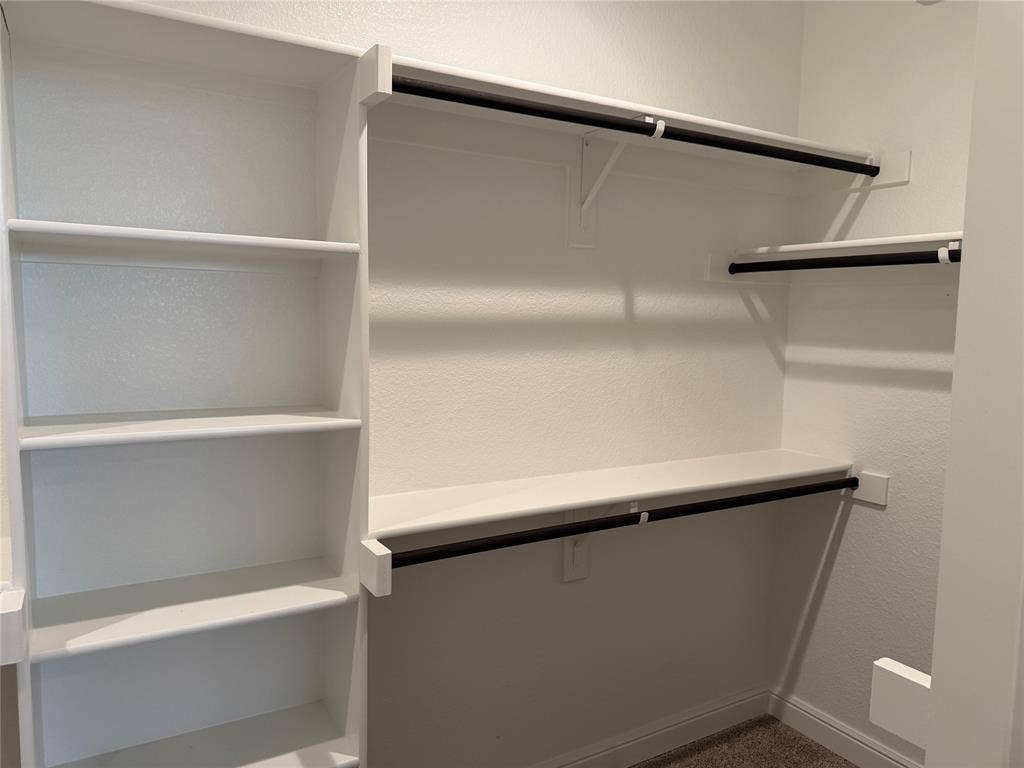 5213 Meadow Lane, Krum, TX 76249 Built-in shelving, multiple hanging rods, and an integrated storage system