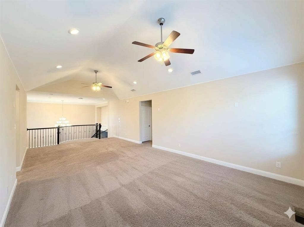 5917 Trantina Lane, Frisco, TX 75035 Vaulted ceiling with recessed lighting, two ceiling fans, carpeted flooring, and a black wrought iron railing