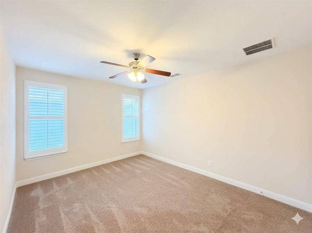 5917 Trantina Lane, Frisco, TX 75035 Neutral wall tones, carpeted flooring, two windows with louvered shutters, and a ceiling fan with integrated lighting