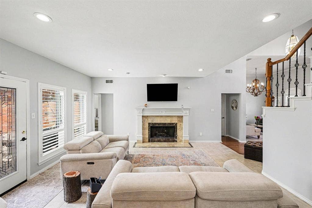 2912 Barksdale Drive, Plano, TX 75025 open-concept living room with cozy fireplace.