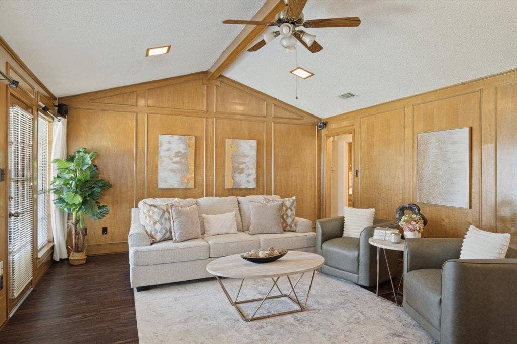 1721 Guildford Street, Garland, TX 75044 The living room is warm and inviting with beautiful paneling and beamed ceiling.