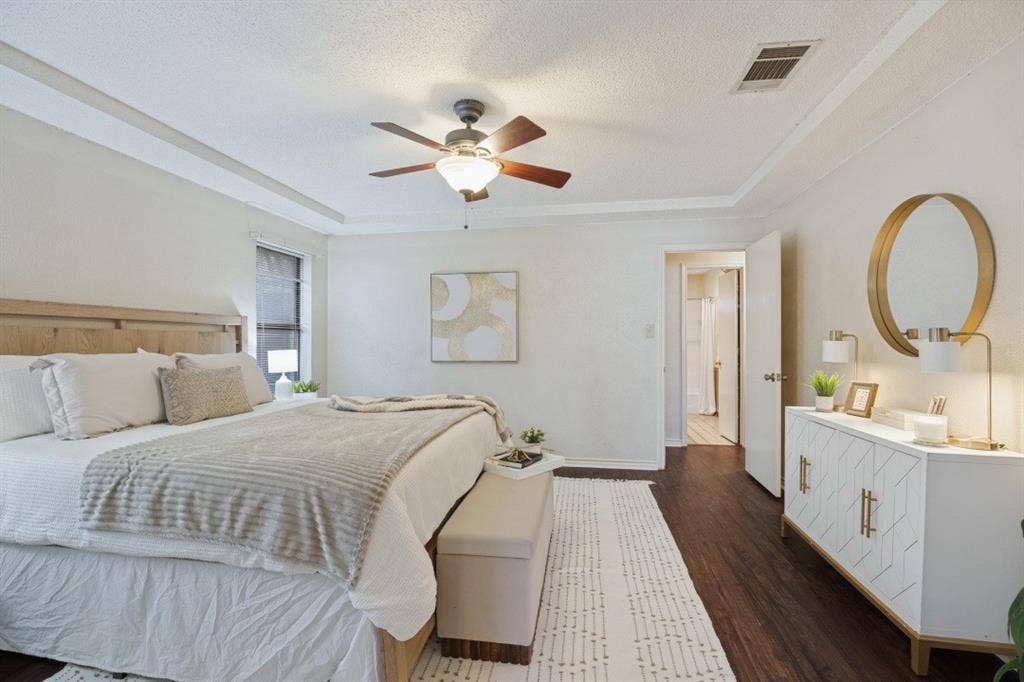 1721 Guildford Street, Garland, TX 75044 The primary bedroom is nice and bright with laminate flooring, and a ceiling fan.