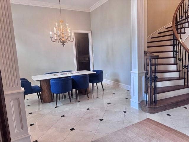 5933 King William Drive, Plano, TX 75093 This space features light-toned tiled flooring with dark square accents, crown molding, and a chandelier