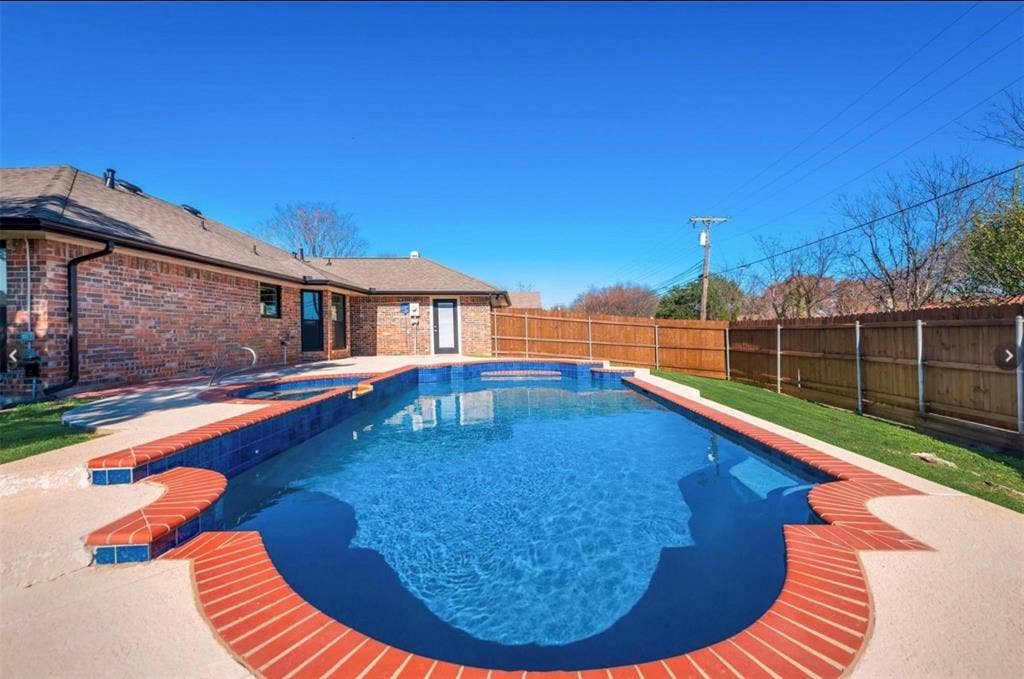 171 Wildwood Drive, DeSoto, TX 75115 Additional view of the backyard oasis featuring the swimming pool, brick patio, and fenced yard.