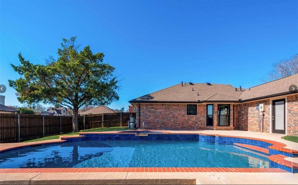 171 Wildwood Drive, DeSoto, TX 75115 Beautiful backyard pool with a depth of up to 8 feet and an attached heated spa.