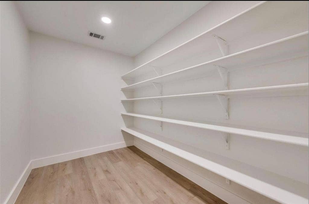 171 Wildwood Drive, DeSoto, TX 75115 Generously sized walk-in pantry with extensive built-in shelving for storage and organization.