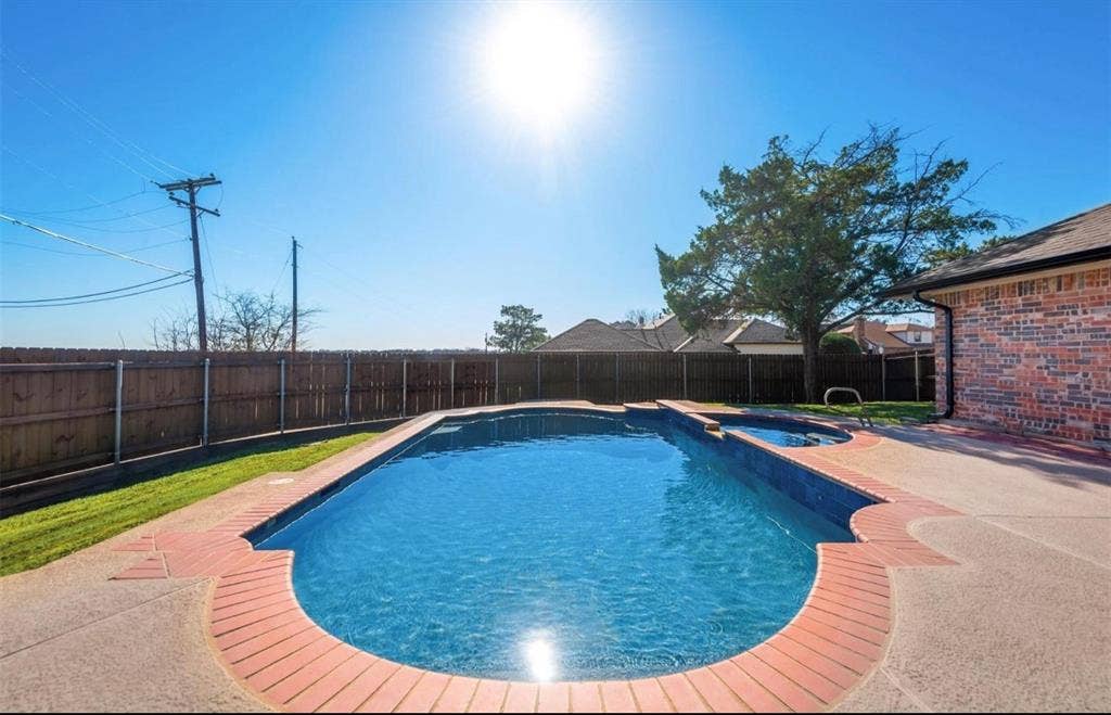 171 Wildwood Drive, DeSoto, TX 75115 Private backyard retreat featuring an in-ground swimming pool and spacious surrounding patio.
