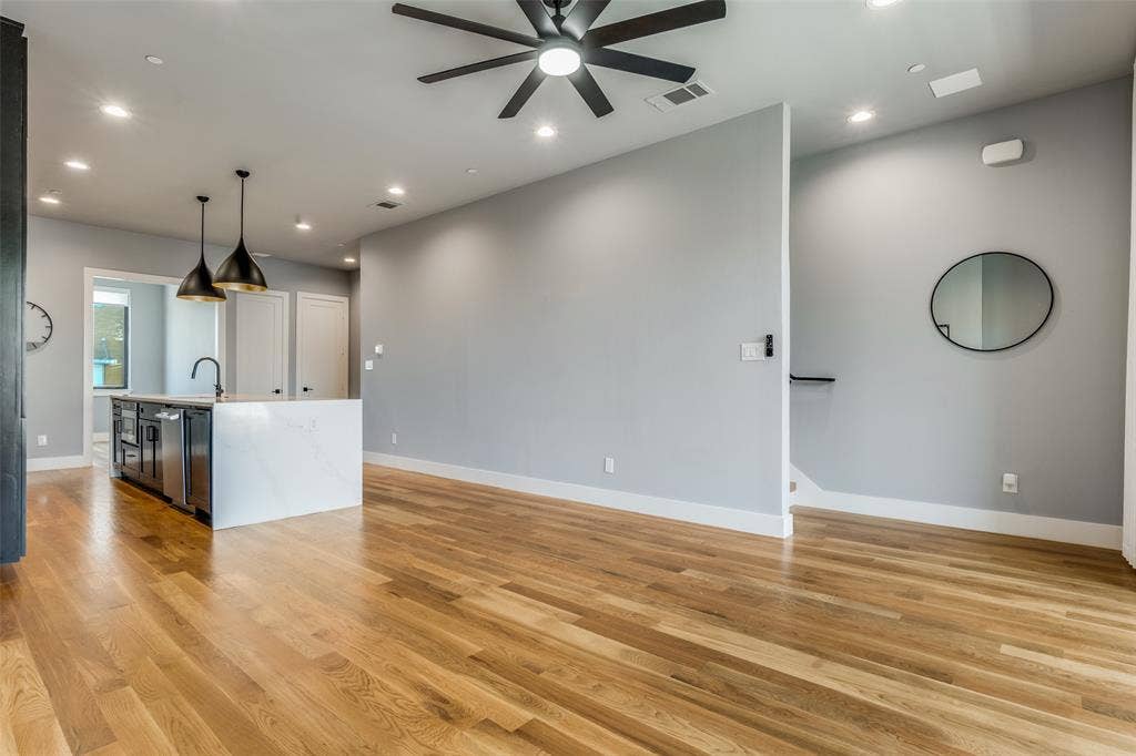805 Pavillion Street, #103, Dallas, TX 75204 Hardwood flooring, recessed lighting, ceiling fan, kitchen island with quartz countertop, and pendant lighting