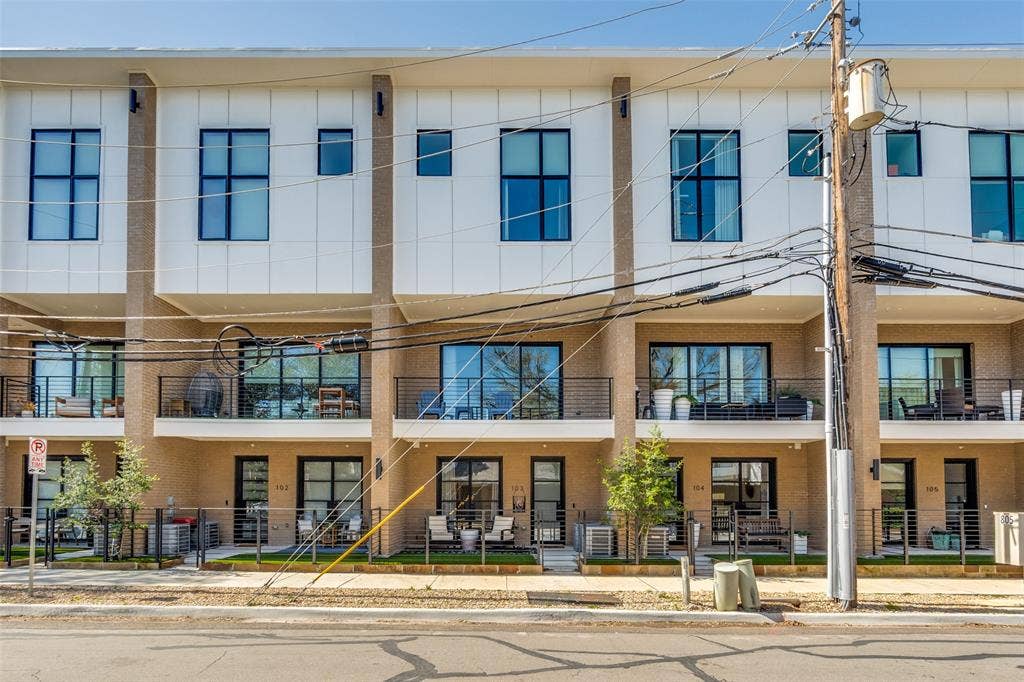 805 Pavillion Street, #103, Dallas, TX 75204 Modern townhome architecture featuring multiple balconies, large windows, and a stucco and panel exterior