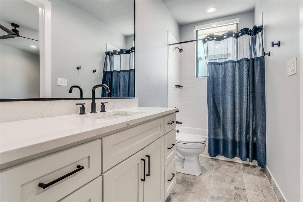 805 Pavillion Street, #103, Dallas, TX 75204 White vanity with shaker-style cabinetry, matte black hardware, and a white countertop
